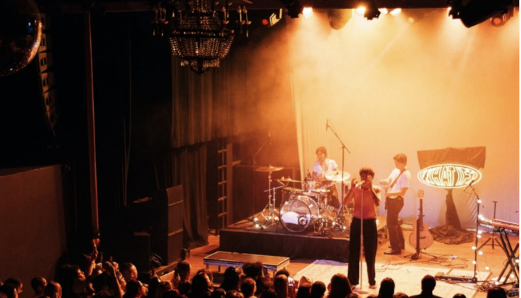 Alexander Stewart's "What if?" tour audience and stage with orange faded lights meeting the fan's energy.